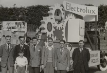 Group picture taken in front of Electrolux banner in Coronation parade, 1953