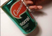 A Cannings sorrel drinks can with wire soldered on one side to make a handle.