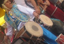 Boy playing a Dohl drum.