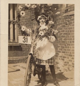 Dorothy Barnes dressed as a Welsh girl with a bicycle. c 1926.